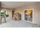 Covered patio featuring stone flooring, stacked firewood, and view to another outdoor seating area at 197 Ebb Tide Cir, Las Vegas, NV 89123