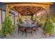 Outdoor dining area with elegant pergola, lighting, and dining table set at 197 Ebb Tide Cir, Las Vegas, NV 89123