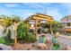 Enchanting backyard with a wooden pergola, outdoor seating, a fire pit, and lush landscaping at 197 Ebb Tide Cir, Las Vegas, NV 89123