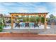 Relaxing pool area features a covered pergola, chairs and a small table at 197 Ebb Tide Cir, Las Vegas, NV 89123