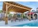 Outdoor living with a covered lounge area, poolside loungers and a serene pool at 197 Ebb Tide Cir, Las Vegas, NV 89123