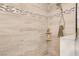 Tiled shower stall featuring a mosaic accent stripe, mounted shower head, and convenient corner shelves at 197 Ebb Tide Cir, Las Vegas, NV 89123