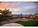Beautiful backyard with low-maintenance landscaping and amazing views of the mountains and colorful sunset at 2099 Mountain City St, Henderson, NV 89052
