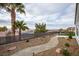 This is a landscaped backyard with a stone walkway and palm trees at 2099 Mountain City St, Henderson, NV 89052