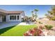 This is a backyard with a covered patio and landscaped flowerbeds at 2099 Mountain City St, Henderson, NV 89052