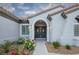 Inviting front entrance with a double door, arched entryway, and beautiful landscaping at 2099 Mountain City St, Henderson, NV 89052