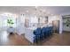 Modern kitchen featuring a large island with waterfall countertops and seating, stainless steel appliances, and pendant lighting at 2099 Mountain City St, Henderson, NV 89052