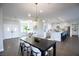 Open-concept living room and kitchen area featuring hardwood floors, modern lighting, and elegant design at 2099 Mountain City St, Henderson, NV 89052
