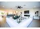 Open-concept living room and kitchen area featuring modern decor, a fireplace, and hardwood floors at 2099 Mountain City St, Henderson, NV 89052