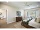 Spacious main bedroom featuring wood floors, a ceiling fan, and a comfortable sitting area at 2099 Mountain City St, Henderson, NV 89052