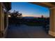 Enjoy twilight views from the cozy covered patio, complete with outdoor seating and lush backyard at 2099 Mountain City St, Henderson, NV 89052