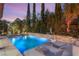 Inviting backyard featuring a sparkling pool, comfortable lounge chairs, and lush landscaping, perfect for relaxation and recreation at 2240 Boutique Ave, Henderson, NV 89044