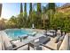 Luxurious backyard with a stunning pool, spa, and elegant lounge area, perfect for relaxation at 2240 Boutique Ave, Henderson, NV 89044