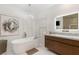 Beautiful bathroom featuring a soaking tub, marble floors, modern lighting, and a sleek vanity with marble countertop at 2240 Boutique Ave, Henderson, NV 89044