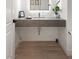 Modern powder room featuring a floating sink and a decorative backsplash with a minimalist design at 2240 Boutique Ave, Henderson, NV 89044
