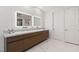 Modern bathroom with a long vanity, double sinks, sleek cabinets, and contemporary tile flooring at 2240 Boutique Ave, Henderson, NV 89044