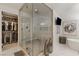 Elegant bathroom featuring a glass shower, soaking tub, custom closet, and modern decor at 2240 Boutique Ave, Henderson, NV 89044