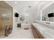 Luxurious bathroom featuring double sinks, a soaking tub, a glass-enclosed shower, and modern fixtures at 2240 Boutique Ave, Henderson, NV 89044