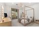 Bright bedroom with canopy bed and access to an outdoor patio at 2240 Boutique Ave, Henderson, NV 89044