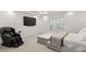 Inviting bedroom with a massage chair, large TV, and a cozy bed, perfect for relaxation at 2240 Boutique Ave, Henderson, NV 89044