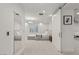 Bright and airy bedroom featuring a full-length mirror, white walls and carpet, modern lighting, and a comfortable king-sized bed at 2240 Boutique Ave, Henderson, NV 89044