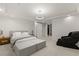 Bright and minimalist bedroom featuring modern lighting, a sliding barn door, and a comfortable king-sized bed and furnishings at 2240 Boutique Ave, Henderson, NV 89044