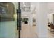 Bright entryway with wood floors leading to an open floor plan and glass-enclosed wine cellar at 2240 Boutique Ave, Henderson, NV 89044