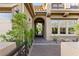 Inviting front entrance with an arched doorway and beautifully landscaped walkway at 2240 Boutique Ave, Henderson, NV 89044