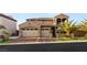 Stately two-story home with a tile roof, manicured landscaping, and a three-car garage, showcasing classic curb appeal at 2240 Boutique Ave, Henderson, NV 89044