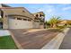 Beautiful two-story home with a tile roof, and a three-car garage, complemented by a well-maintained front yard and landscaping at 2240 Boutique Ave, Henderson, NV 89044