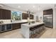 Modern kitchen features a large island with seating, a wine cooler, and stainless steel appliances at 2240 Boutique Ave, Henderson, NV 89044