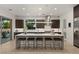 Contemporary kitchen featuring a large island with bar stools, stainless steel appliances, and ample cabinetry at 2240 Boutique Ave, Henderson, NV 89044