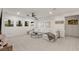 Spacious living room with white sofa, round glass coffee table, and natural light from large windows at 2240 Boutique Ave, Henderson, NV 89044