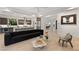 Open-concept living space with wood floors, modern furnishings, and a view into the kitchen at 2240 Boutique Ave, Henderson, NV 89044