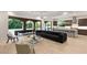 Bright living room with a modern sofa, hardwood floors, and sliding doors to the patio at 2240 Boutique Ave, Henderson, NV 89044
