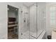 Modern shower featuring glass enclosure, rainfall shower head, and built-in bench at 2240 Boutique Ave, Henderson, NV 89044