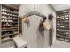 Organized walk-in closet featuring custom shelving for shoes and hanging space for bags at 2240 Boutique Ave, Henderson, NV 89044