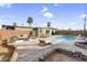 Backyard features a sparkling pool, patio seating, and lush landscaping, ideal for outdoor entertaining at 2801 Emmons Ave, North Las Vegas, NV 89030