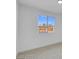 Bright bedroom featuring neutral carpet, white walls, and a window with neighborhood views at 2801 Emmons Ave, North Las Vegas, NV 89030