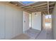 View of the home's front entrance. It features a metal security door and concrete walkway at 2801 Emmons Ave, North Las Vegas, NV 89030