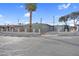 View of the front of the home from the street. Includes mature landscaping, an iron gate and privacy wall at 2801 Emmons Ave, North Las Vegas, NV 89030