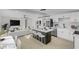 Sunlit living space includes a modern kitchen with an island, a dining area, and comfortable living room at 2801 Emmons Ave, North Las Vegas, NV 89030