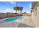 Backyard featuring a sparkling pool, concrete patio, and wood fence at 2801 Emmons Ave, North Las Vegas, NV 89030