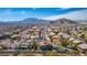 Stunning aerial view of a neighborhood with mountain views, mature trees, and well-maintained homes at 3924 Diamond Ridge St, Las Vegas, NV 89129
