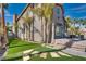Spacious backyard with artificial turf, a patio seating area, and a lush landscape design at 3924 Diamond Ridge St, Las Vegas, NV 89129