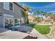 Backyard featuring a patio with a grill, lush landscaping, mature trees, and outdoor dining and seating areas at 3924 Diamond Ridge St, Las Vegas, NV 89129