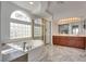 Luxurious bathroom with a jetted tub, walk-in shower, and dual sinks offers a spa-like experience at 3924 Diamond Ridge St, Las Vegas, NV 89129