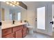 Elegant bathroom with a double sink vanity and frosted glass door at 3924 Diamond Ridge St, Las Vegas, NV 89129