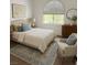 Well-lit bedroom features carpet, rug, bed, accent chair, and window at 3924 Diamond Ridge St, Las Vegas, NV 89129