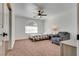 Cozy bedroom with carpet, window, ceiling fan, and sitting chair at 3924 Diamond Ridge St, Las Vegas, NV 89129